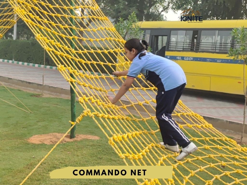 A girl climbing a yellow commando net obstacle