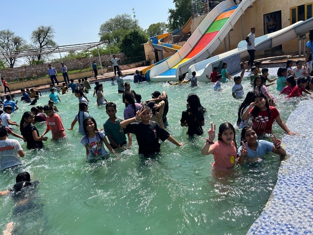 Children and adults enjoying a water park with slides