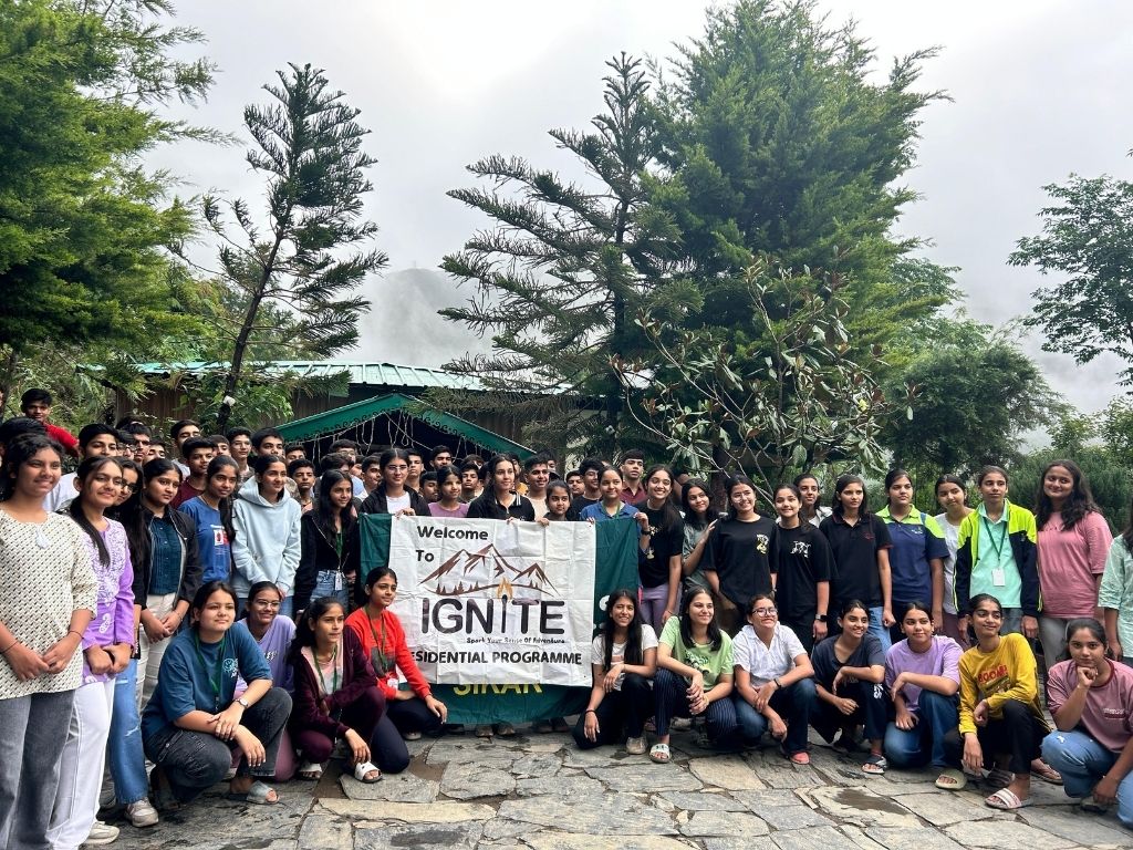 Students holding an 'Ignite Residential Programme' banner