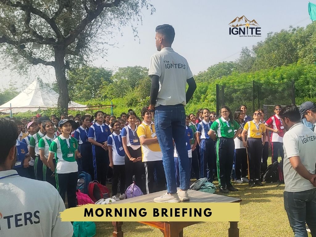 An instructor giving a morning briefing to a group of students