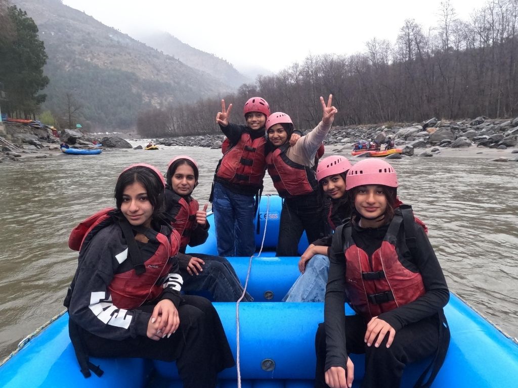 Group of young people in a raft on a river