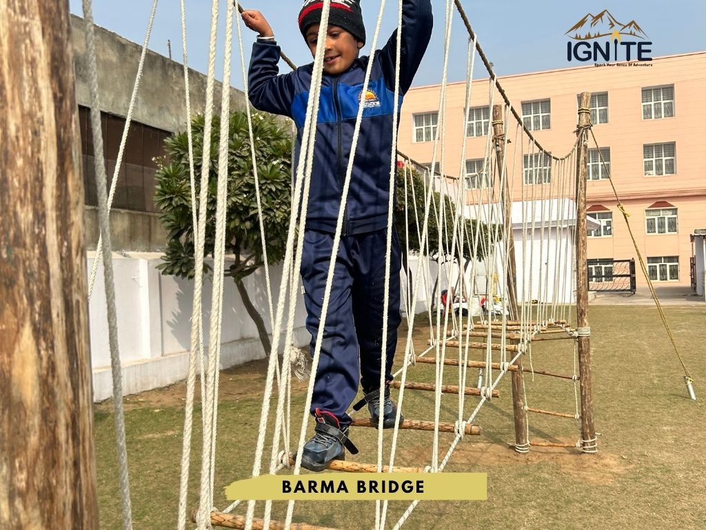 A student crossing a Barma Bridge obstacle course