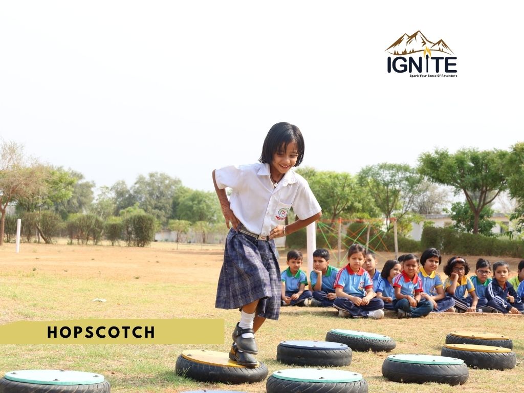 A student playing hopscotch on outdoor markers