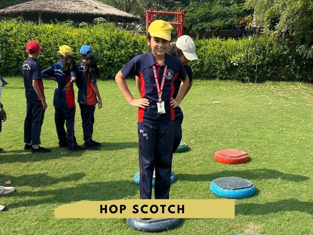 A student standing on a hopscotch marker during an activity